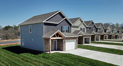 New suburban townhomes lined along driveway,